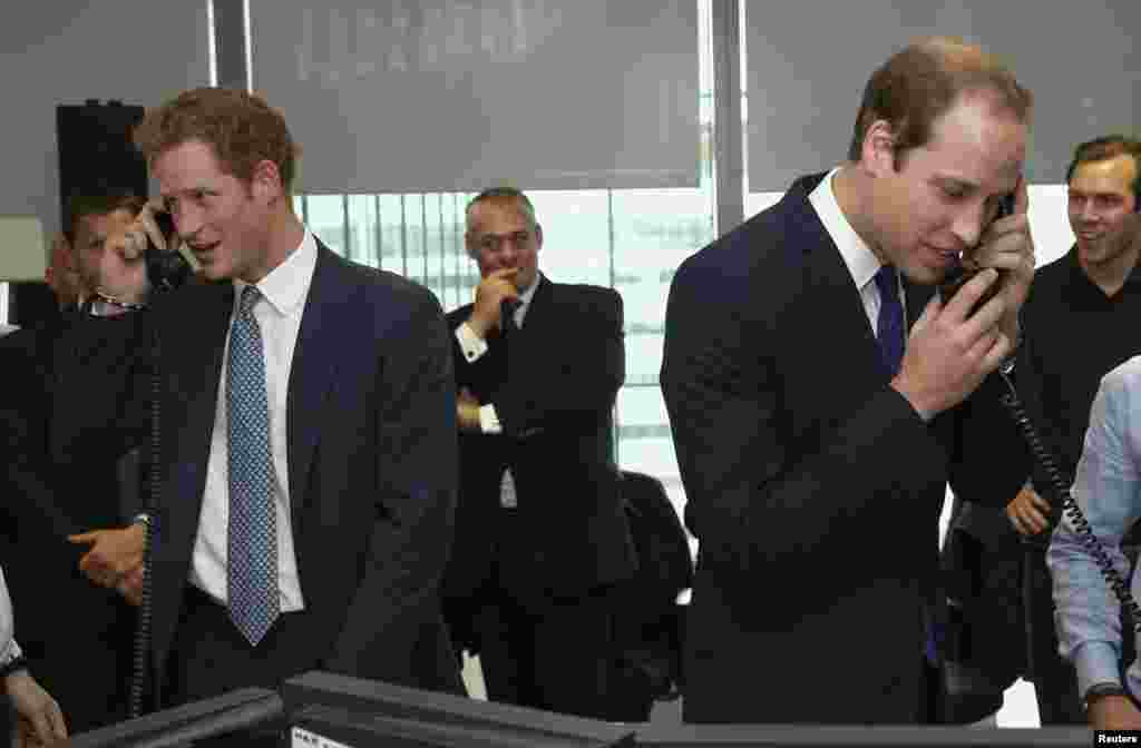 Britain's Prince Harry and Prince William take part in a trade on the floor of BGC Partners as part of a 9/11 commemoration, London, Sept. 11, 2013. 