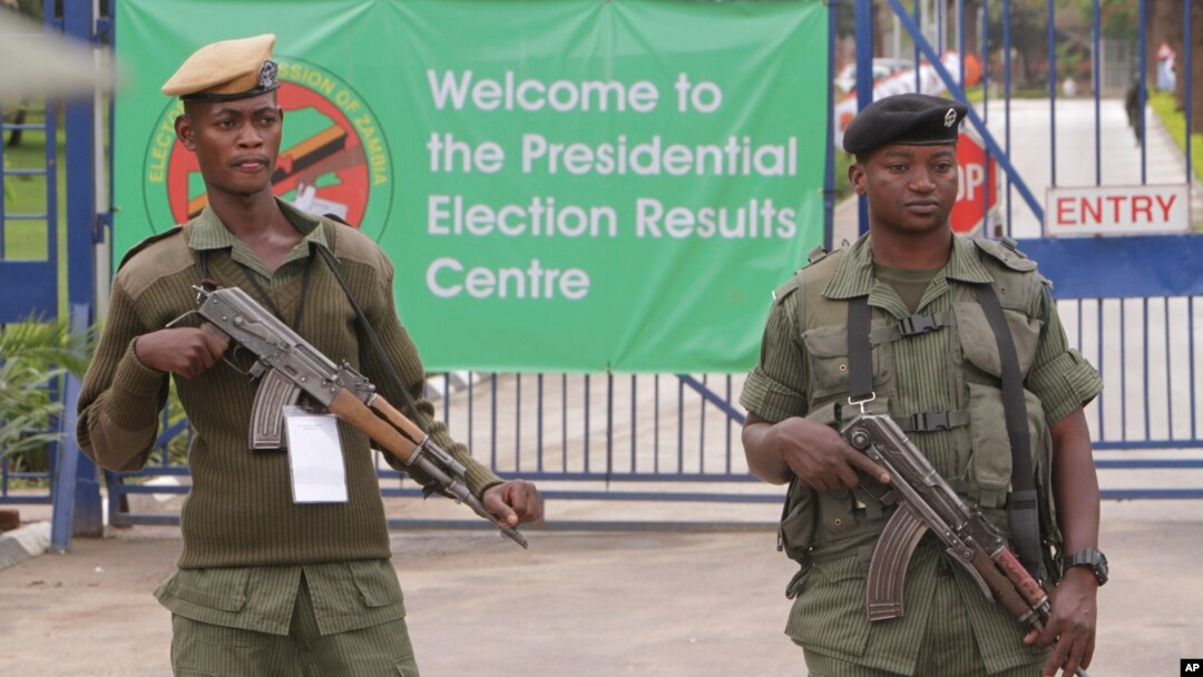 FILE - Armed police officers stand guard outside the presidential election results center in Lusaka, Zambia, Jan, 21, 2015.