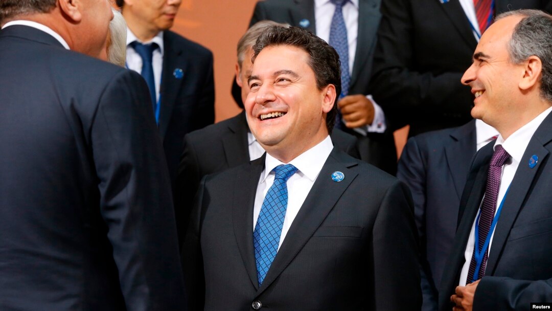 FILE - Turkey's Deputy Prime Minister Ali Babacan gathers with other delegates for a photo after a meeting of G-20 finance ministers and central bank governors during the IMF-World Bank annual meetings in Washington, Oct. 10, 2014. 