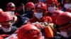 Medics and rescue personnel carry an injured person from the debris of a collapsed building in Izmir, Turkey, Oct. 31, 2020. 