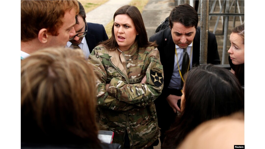 In a borrowed U.S. Army jacket to keep warm, White House press secretary Sarah Huckabee Sanders updates reporters on President Donald Trump's failed attempt, preempted by weather, to visit Observation Post Ouellette along the Demilitarized Zone (DMZ) in the truce village of Panmunjom dividing North Korea and South Korea outside Seoul, South Korea, Nov. 8, 2017