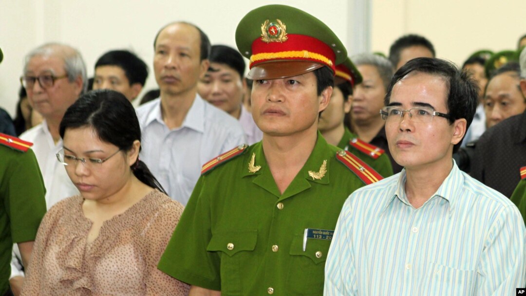 FILE - A U.S-trained lawyer and well-known dissident Le Quoc Quan, right, listens to the judge during his trial in Hanoi, Vietnam.