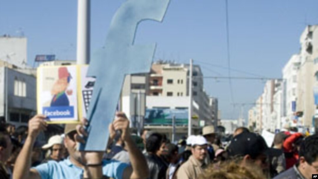 A protester holds up a cut-out of the letter "F" in an apparent recognition of the social network site Facebook's role in the recent revolts in Arab countries, Rabat, Morocco, March 20, 2011