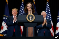 President Donald Trump and Vice President Mike Pence applaud incoming Central Intelligence Agency director Gina Haspel during a swearing-in ceremony at CIA headquarters in Langley, Va., May 21, 2018.
