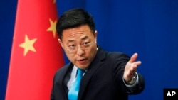 FILE - In this Feb. 24, 2020, photo, Chinese Foreign Ministry spokesman Zhao Lijian speaks during a daily briefing at the Ministry of Foreign Affairs in Beijing.