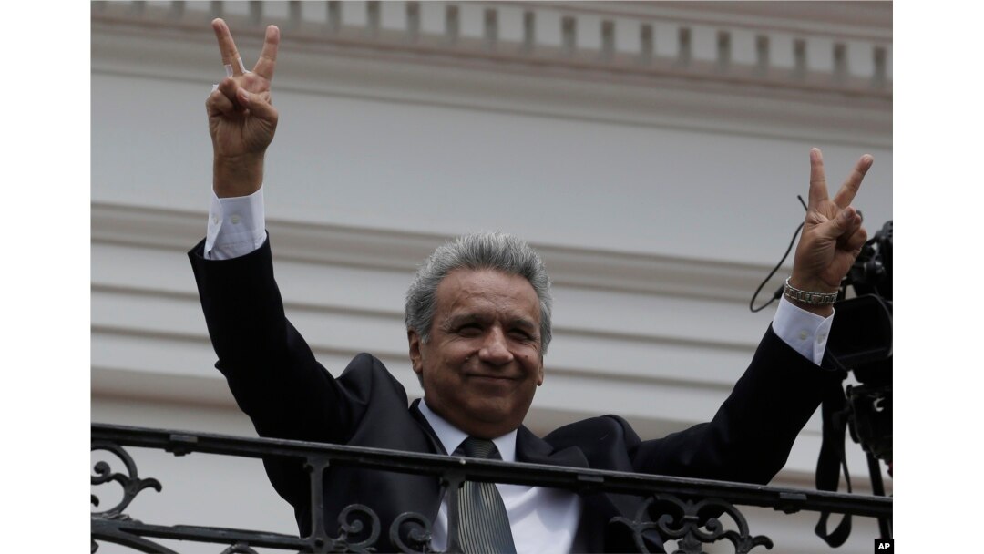 Ecuador's President Lenin Moreno flashes victory hands as he greets supporters from the Government Palace's balcony during the weekly Changing of the Guard, in Quito, Ecuador, Feb. 5, 2018.