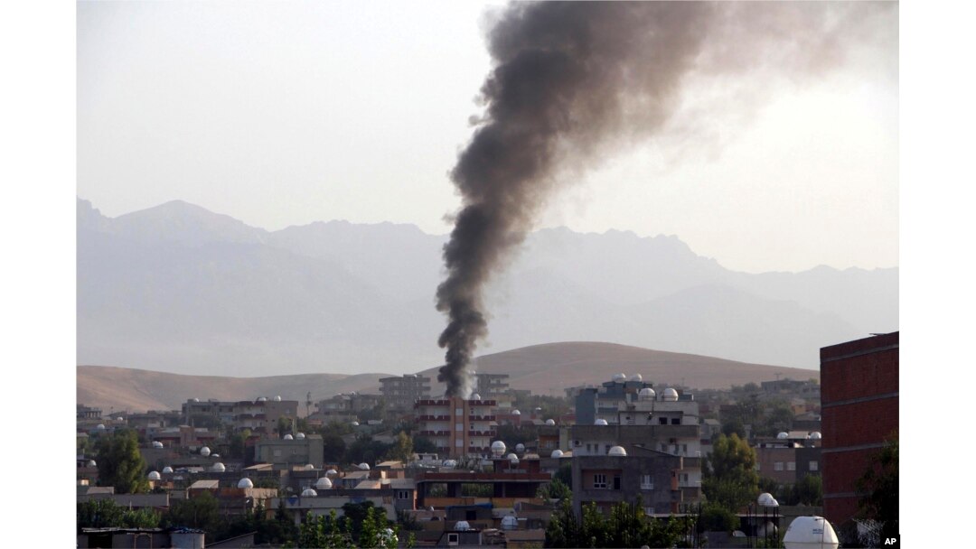 FILE - Smoke billows from a fire during firefight between the police and Kurdistan Workers' Party, or PKK militants in the town of Silopi, southeastern Turkey, July 7, 2015.