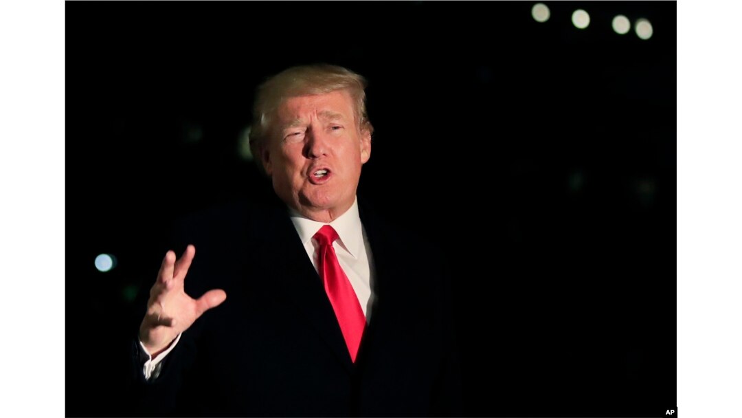 President Donald Trump speaks to reporters upon arrival at the White House in Washington, Jan. 26, 2018, from the World Economic Forum in Davos, Switzerland.