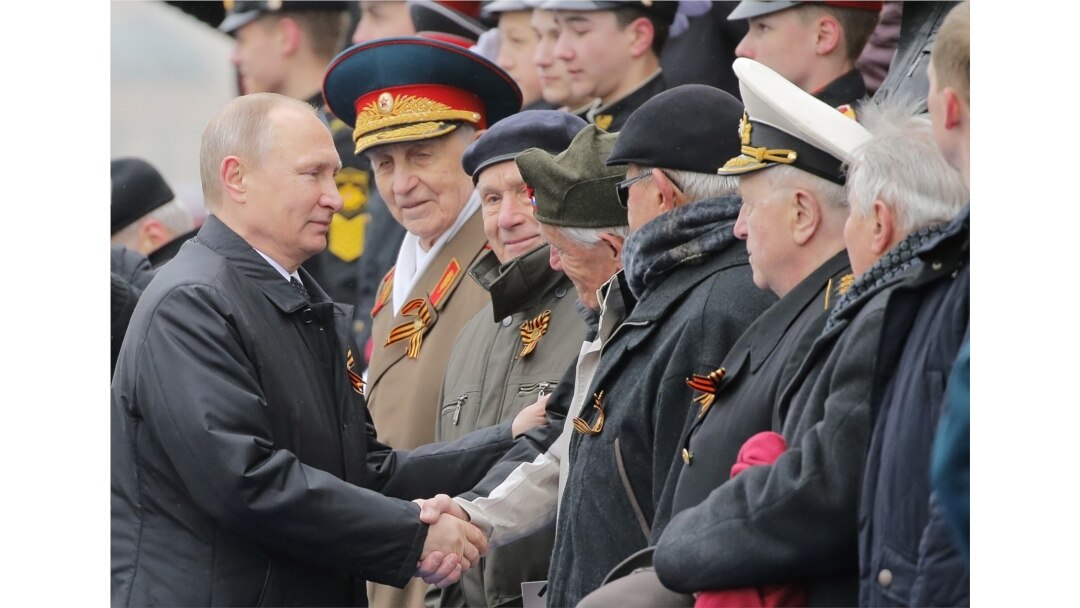 FILE - Russian President Vladimir Putin shakes hands with veterans after the the Victory Day military parade marking the World War II anniversary at Red Square in Moscow, May 9, 2017.