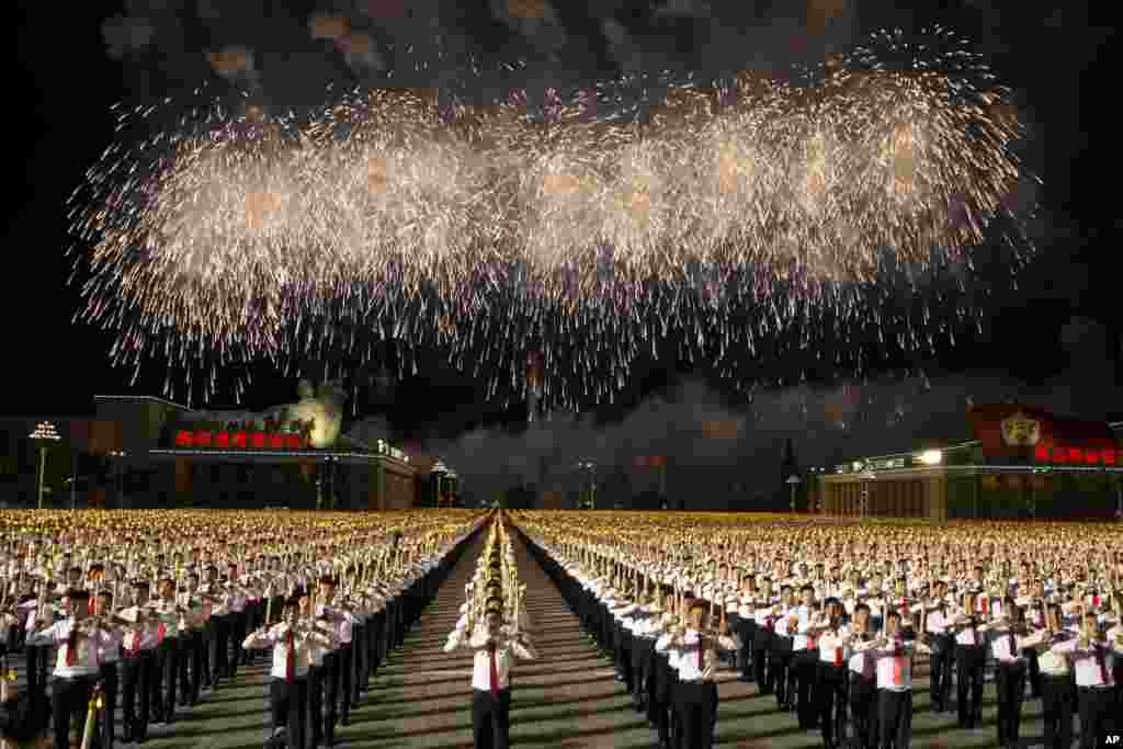 Students take part in a torch light march held in conjunction with the 70th anniversary of North Korea's founding day celebrations in Pyongyang, North Korea.