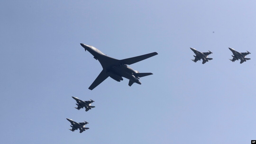 U.S. B-1 bomber, center, flies over Osan Air Base with U.S. jets in Pyeongtaek, South Korea, Tuesday, Sept. 13, 2016.