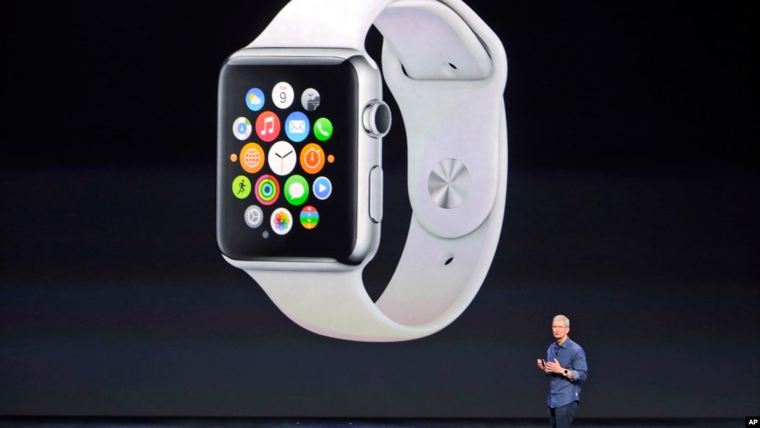 FILE - Apple CEO Tim Cook introduces the new Apple Watch on Tuesday, Sept. 9, 2014, in Cupertino, Calif. Apple's new wearable device marks the company's first major entry in a new product category since the iPad's debut in 2010.