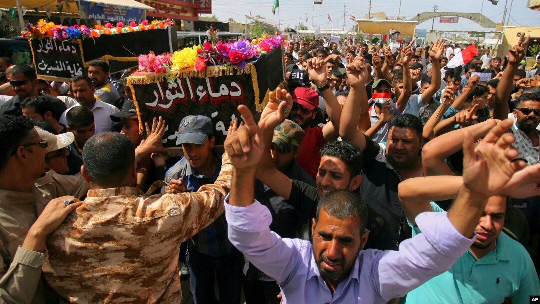 Mourners carry the coffins of two people, killed in protests at Baghdad's International Zone on Friday, during their funeral procession at the holy shrine of Imam Ali, in Najaf, 160 kilometers south of Baghdad, Iraq, May 21, 2016. 