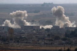 Smoke and dust billow from targets in Ras al-Ayn, Syria, caused by bombardment by Turkish forces, Oct. 15, 2019.