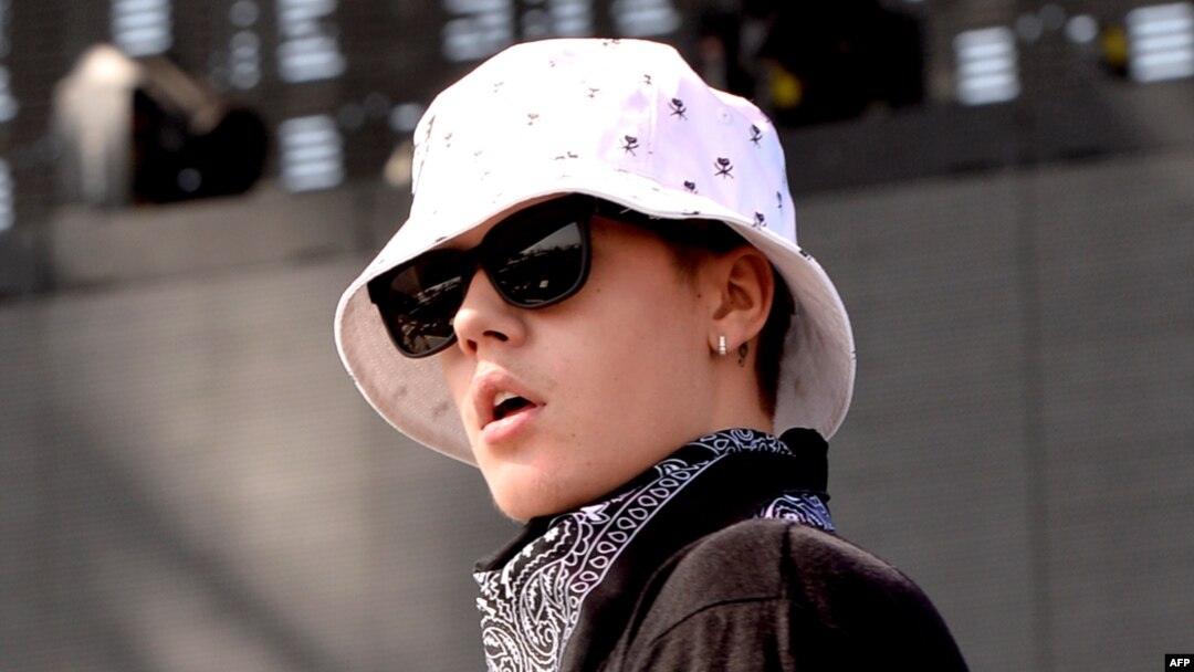 FILE - Singer Justin Bieber performs with Chance The Rapper during Day 3 of the 2014 Coachella Valley Music & Arts Festival.