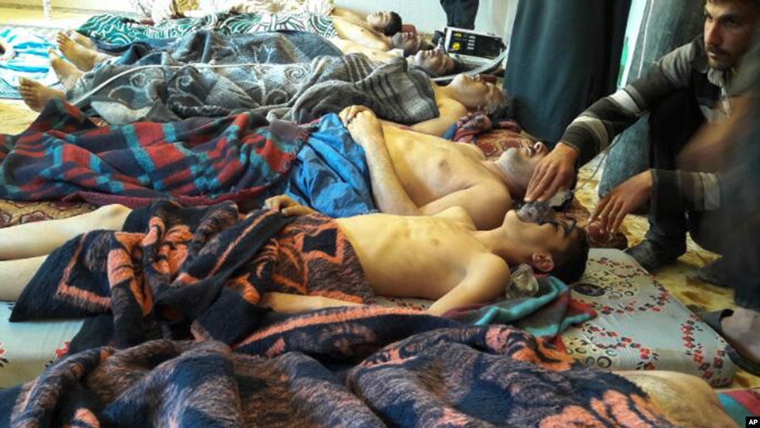 FILE - Victims of a suspected chemical weapons attack lie on the ground in Khan Sheikhoun, Idlib province, Syria, April 4, 2017. The Organization for the Prohibition of Chemical Weapons said Thursday it has evidence that another town was attacked with sarin gas days earlier.