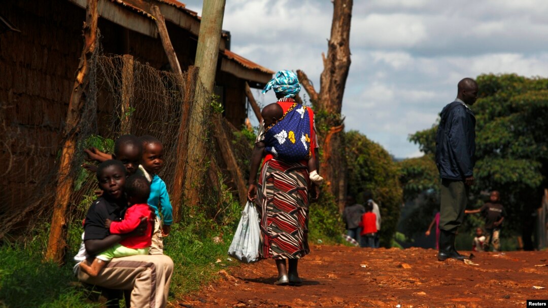 FILE - A mother carries her baby on her back in Kenya.