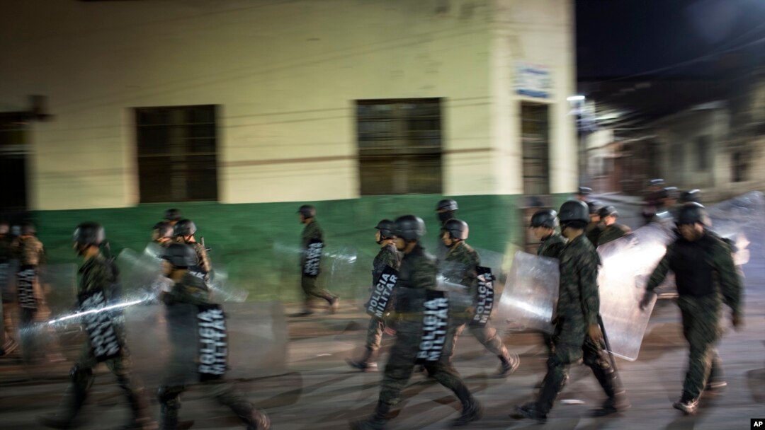 Military police patrols during government imposed dawn-to-dusk curfew in Tegucigalpa, Honduras, late Saturday, Dec. 2, 2017. The main opposition candidate called Saturday for Honduras' disputed presidential election to be held again after the country erupted in deadly protests over the delayed vote count. 