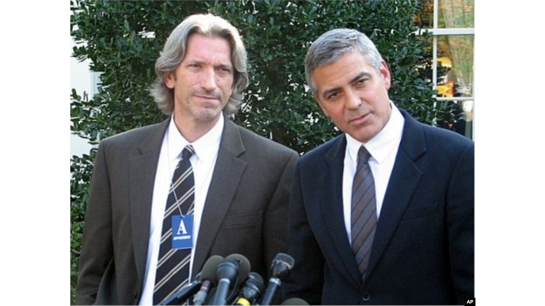 Actor, activist George Clooney (R) with activist John Prendergast