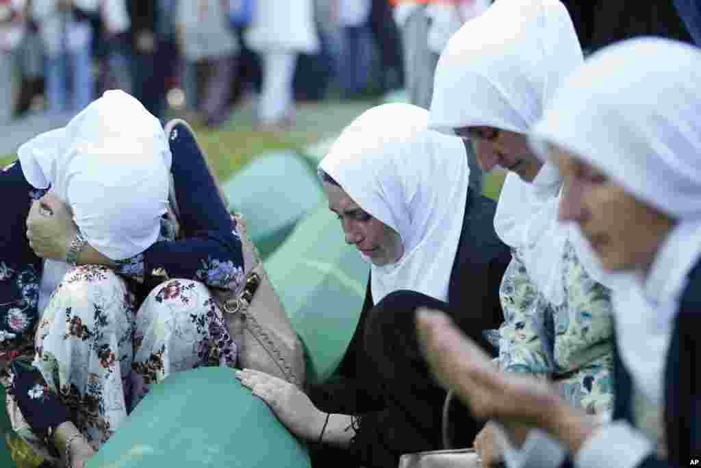 Bosnian Muslim women react near the coffin of one of the 35 identified victims of the 1995 massacre, at the memorial center of Potocari near Srebrenica, 150 kilometers northeast of Sarajevo. Thousands of Bosnian Muslims have gathered in Srebrenica on the 23rd anniversary of Europe's worst massacre since World War II to hold prayers and attend the funeral for 35 recently identified victims.