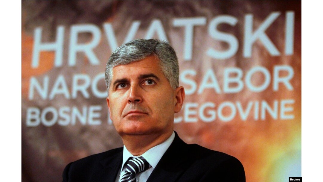 FILE - Newly elected President of Croatian National Parliament and President of HDZ political party (Croatian Democratic Union) Dragan Covic listens during a news conference after a meeting in Mostar, April 19, 2011.