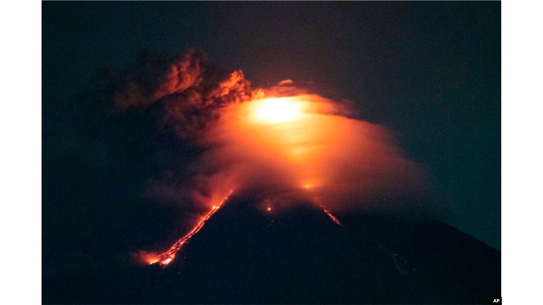 Lava cascades down the slopes of Mayon volcano as seen from Legazpi city, Albay province, around 340 kilometers (210 miles) southeast of Manila, Philippines, Monday, Jan. 15, 2018.