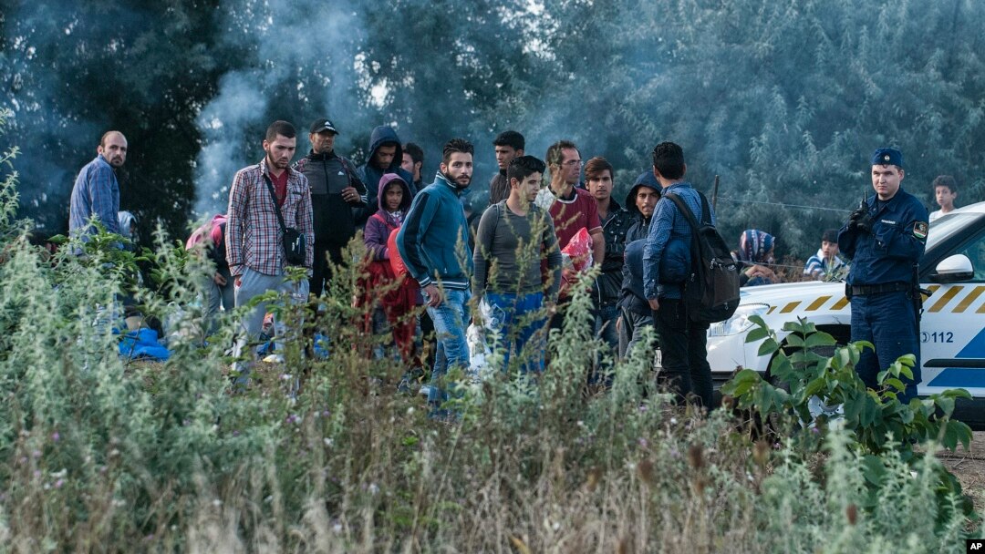 Illegal migrants are seen at the railway crossing at the border between Hungary and Serbia near Roszke, 180 kms southeast from Budapest, Hungary, Aug. 25, 2015. 