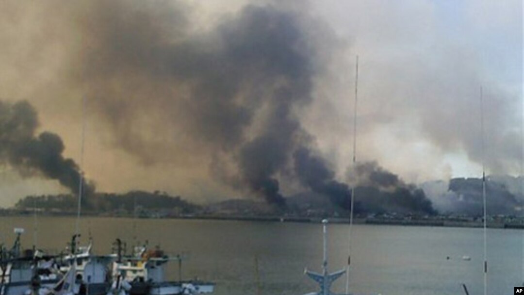 Smoke billow from Yeonpyeong island near the border against North Korea, in South Korea, 23 Nov 2010