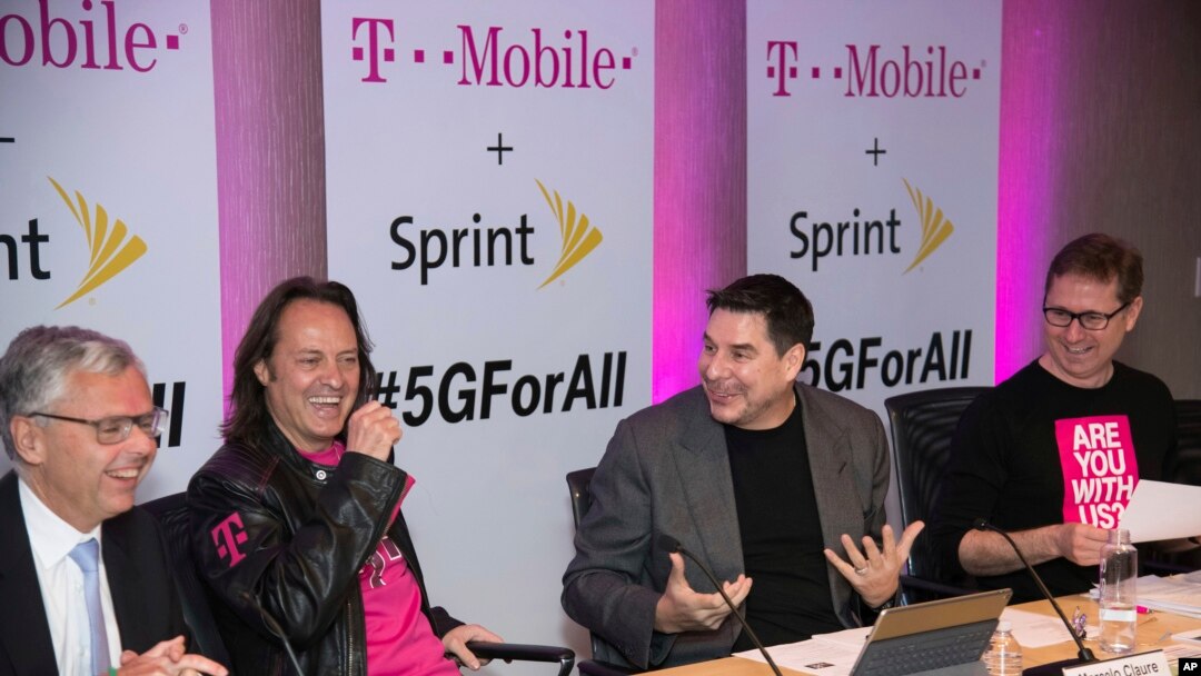 T-Mobile and Sprint executives enjoy a laugh as they accounce the two companies' planned merger April 29, 2018, in New York.