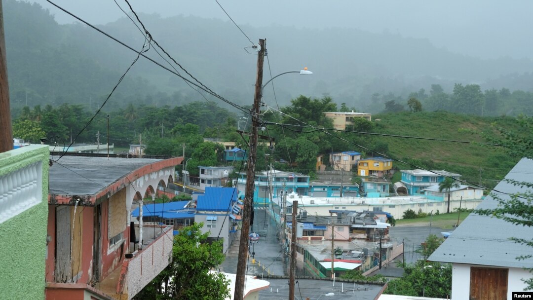 FILE - Houses from a seaside neighborhood are seen as Tropical Storm Karen approaches in Naguabo, Puerto Rico, Sept. 24, 2019.