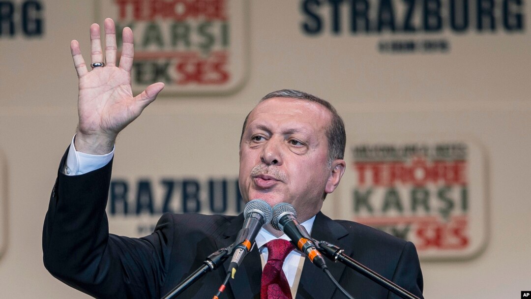 FILE - Turkey's President Recep Tayyip Erdogan gestures as he speaks to supporters of his ruling Justice and Development Party as they rally to denounce violence by Kurdish rebels, in Strasbourg, eastern France, Oct. 4, 2015. 