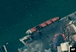 This satellite image provided by the Department of Justice shows what the DoJ says is the North Korean cargo ship Wise Honest docked at a unknown port.