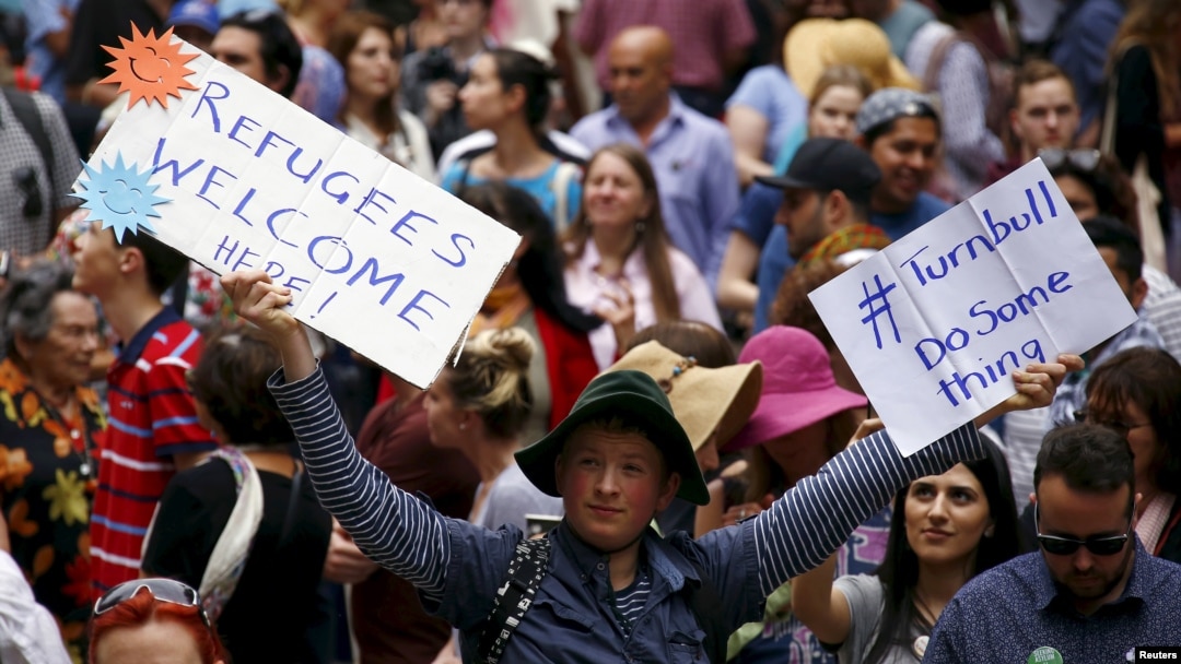 FILE - Demonstrators hold aloft placards during a rally in support of refugees that was part of a national campaign in central Sydney, Australia, Oct. 11, 2015. 