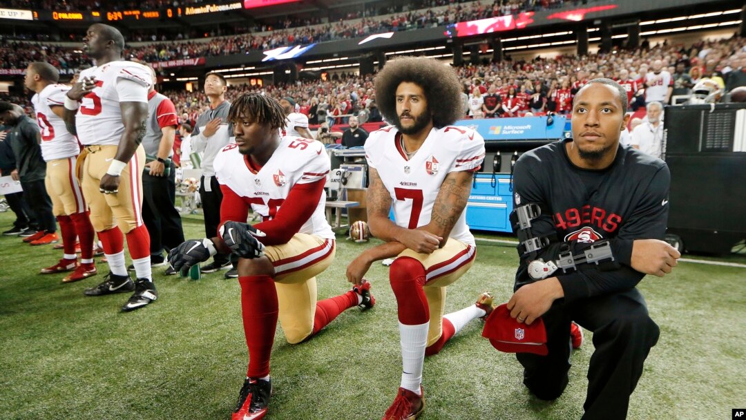 FILE - San Francisco 49ers quarterback Colin Kaepernick (7) and outside linebacker Eli Harold (58) kneel during the playing of the national anthem before an NFL football game against the Atlanta Falcons in Atlanta. 
