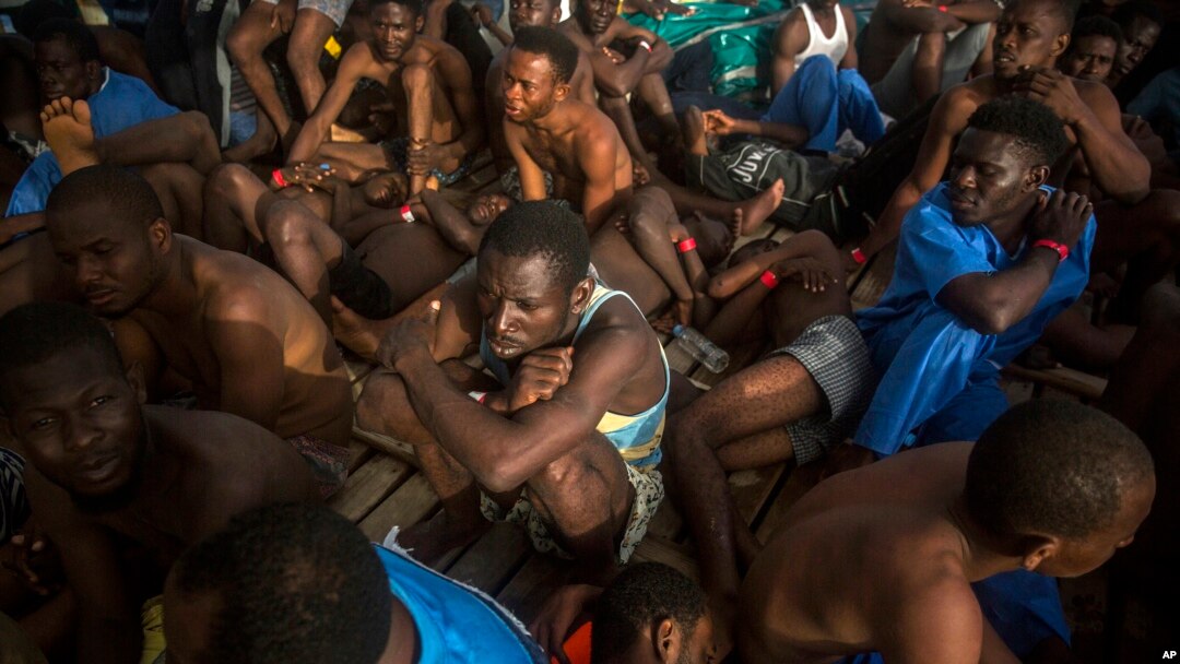FILE - Migrants sit on the deck of a Proactiva Open Arms vessel after being rescued in the Mediterranean Sea, about 15 miles north of Sabratha, Libya, July 25, 2017. 