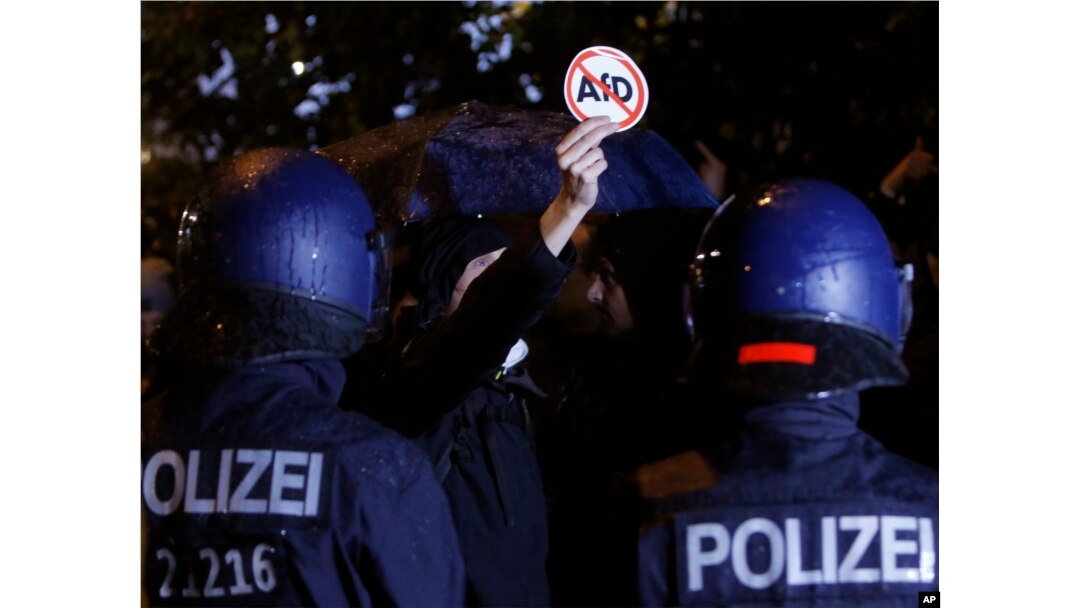 Police block demonstrators protesting the nationalist Alternative for Germany, AfD, party in Berlin, Germany, Sept. 24, 2017.