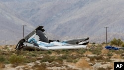 FILE - Wreckage lies near the site where a Virgin Galactic passenger spaceship, SpaceShipTwo, exploded and crashed in Mojave, California, Oct. 31, 2014. 