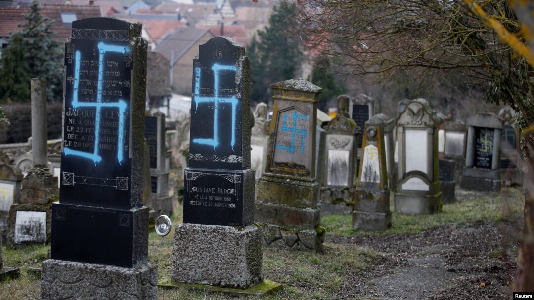 Graves desecrated with swastikas are seen in the Jewish cemetery in Quatzenheim, near Strasbourg, Feb. 19, 2019.