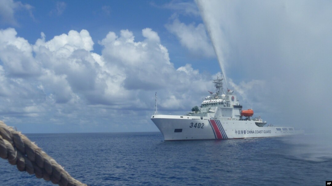 In this Sept.23, 2015 photo provided by Renato Etac, Chinese Coast Guard members approach Filipino fishermen as they confront them off Scarborough Shoal at South China Sea, in northwestern Philippines. (Renato Etac via AP)