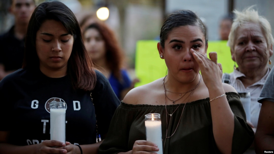 Jennifer Hernandez (L) and Paola Rodriguez, Deferred Action for Childhood Arrivals (DACA) program recipients, participate in a candle vigil at the San Jacinto Plaza in El Paso, Texas, Sept. 5, 2017. 