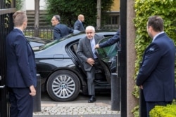 Iran's Foreign Minister Javad Zarif is surrounded by bodyguards as he arrives for a meeting in Oslo, Norway, Aug. 22, 2019.