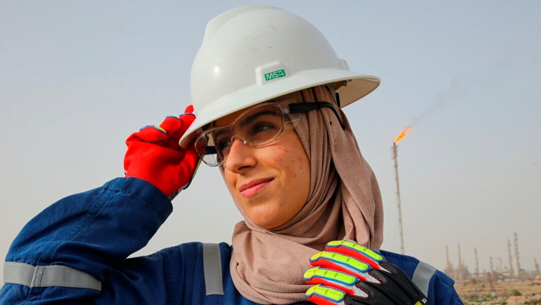 Zainab Amjad, a petrochemical engineer, poses for a photo near an oil field outside Basra, Iraq, Monday, February 18, 2021. (AP Photo/Nabil al-Jourani)