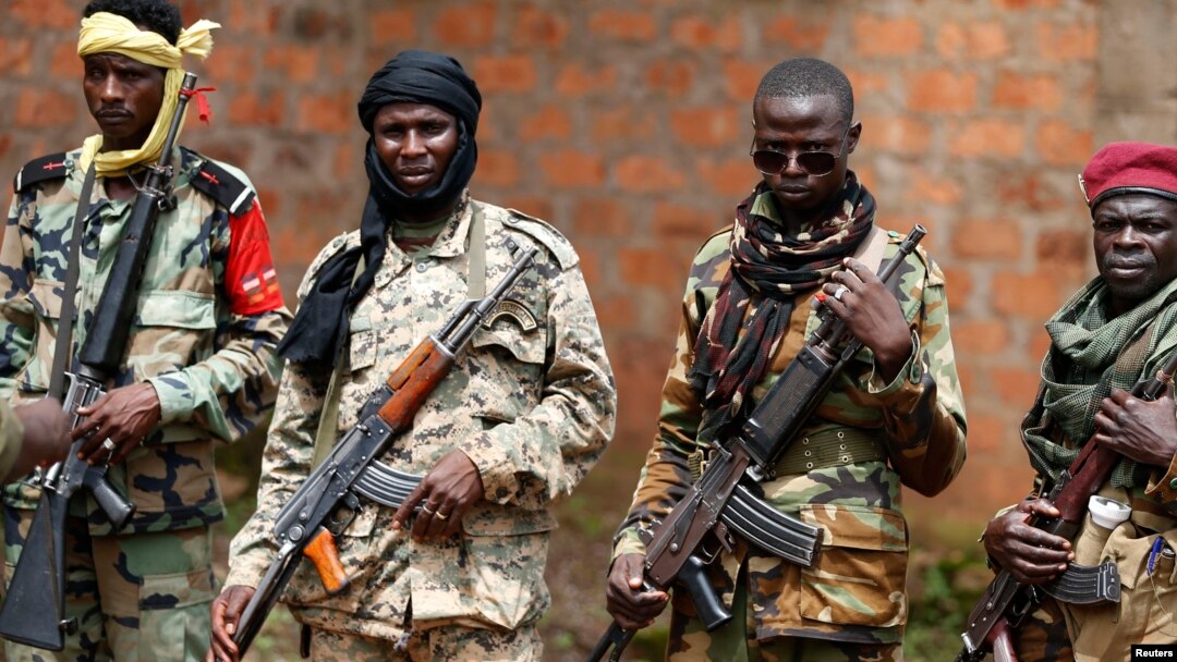 Seleka fighters warily eye a photographer at their base in Bambari, Central African Republic, on May 31, 2014. 