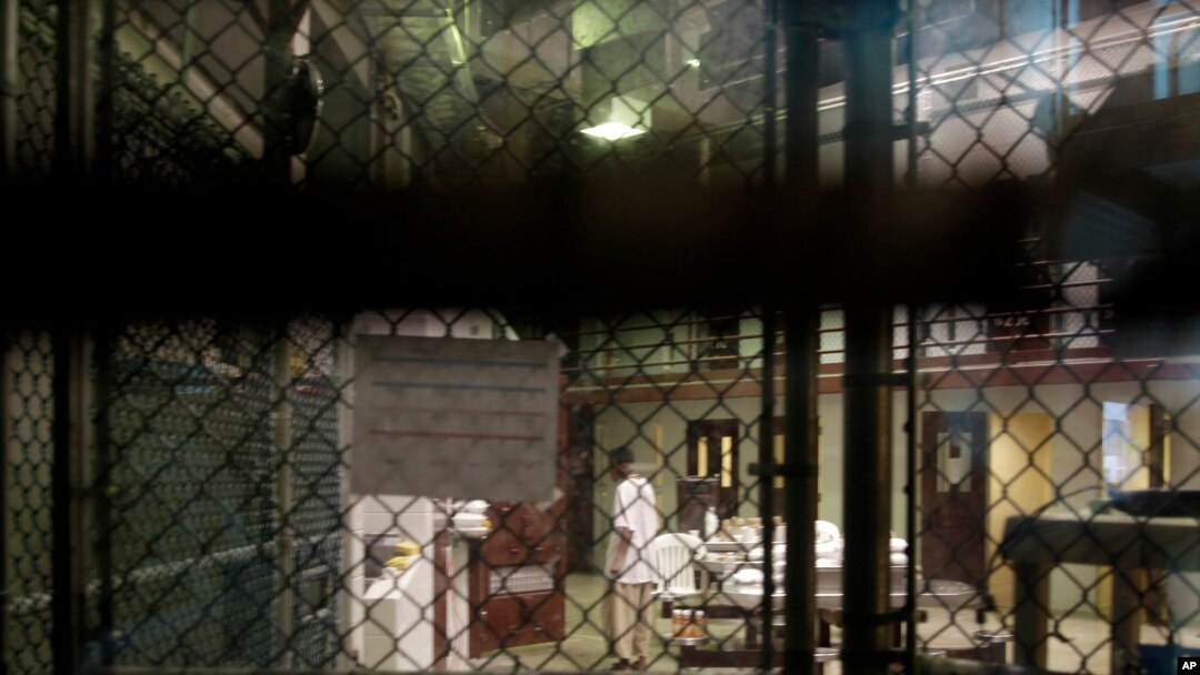 FILE - A prisoner walks through a communal pod inside an area of the Guantanamo Bay detention center known as Camp 6, at Guantanamo Bay Naval Base, Cuba, June 7, 2014.