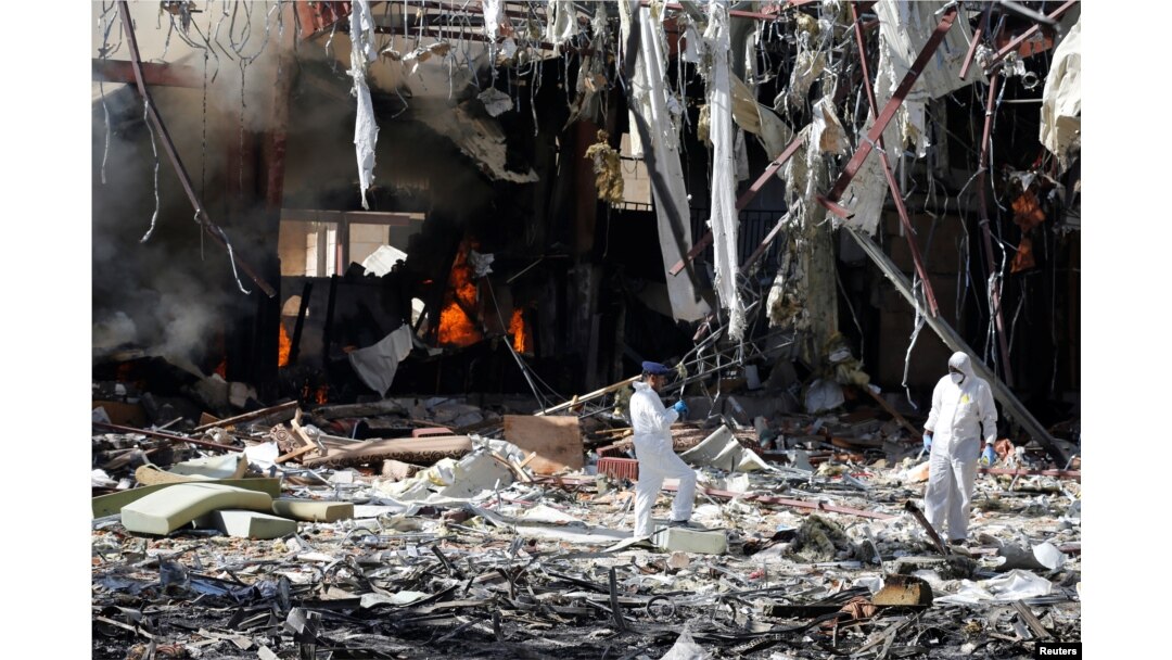 FILE - Forensic experts investigate the scene at the community hall where Saudi-led warplanes struck a funeral in Sana'a, Yemen, Oct. 9, 2016.