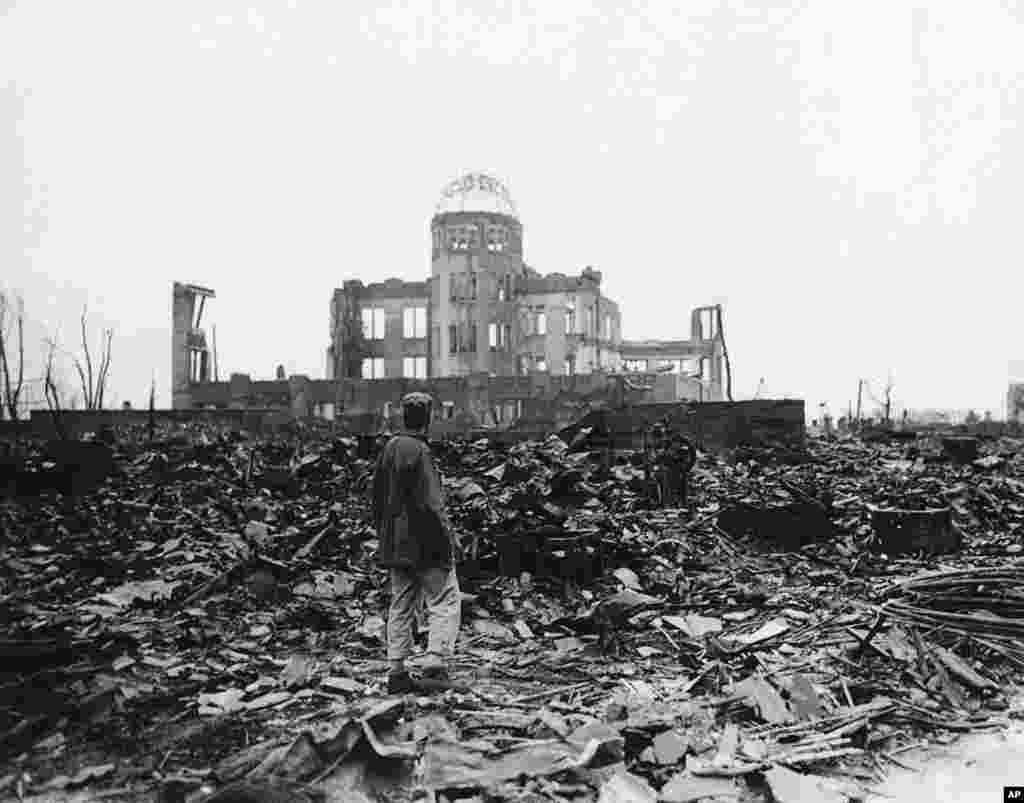 An Allied war correspondent stands amid the ruins of Hiroshima, Japan in 1945, just weeks after the city was leveled by an atomic bomb.