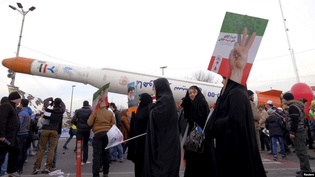 People are seen gathered around a model of Simorgh satellite-carrier rocket displayed during a ceremony marking the 37th anniversary of the Islamic Revolution, in Tehran, Iran, Feb. 11, 2016. 