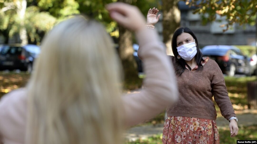 Women exercise during a therapy session in a park in Sarajevo, Bosnia Monday, Oct. 26, 2020. (AP Photo/Kemal Softic)