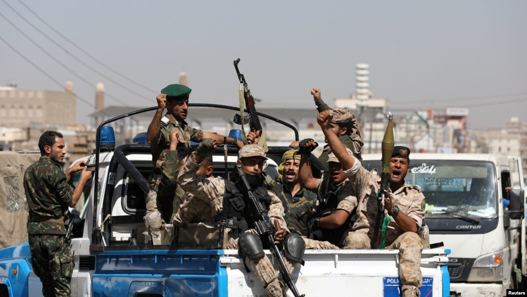 FILE - Houthi troops ride on the back of a police patrol truck after participating in a Houthi gathering in Sana'a, Yemen, Feb. 19, 2020.