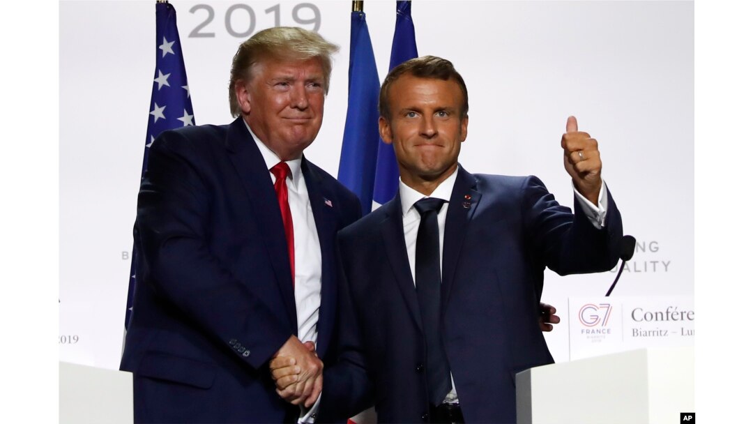 FILE - U.S. President Donald Trump and French President Emmanuel Macron shake hands at the G-7 summit on Aug. 26, 2019, in Biarritz, France.